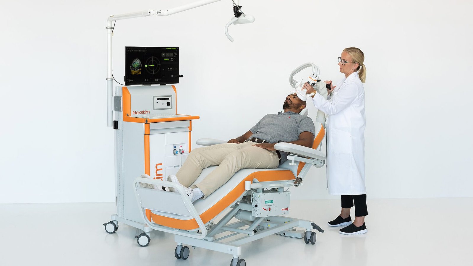 Nexstim NBS 6 navigated TMS system delivering a therapy session with the coil positioned over the patient's head